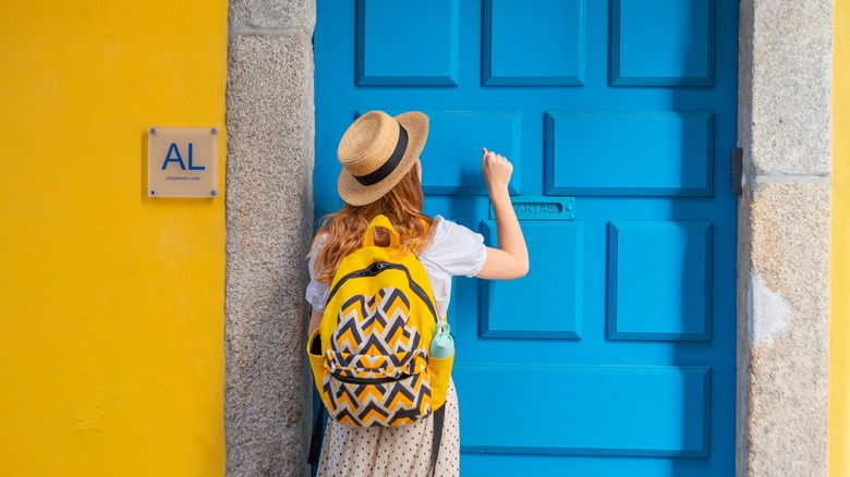 Woman at hostel door in Portugal