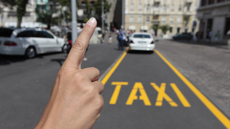 hand hailing a taxi