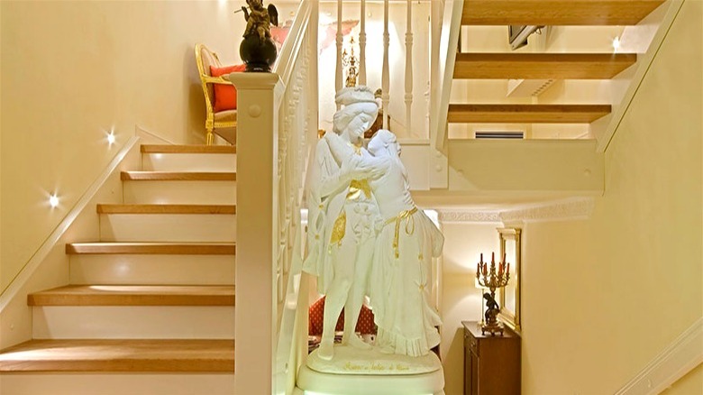 Multi-level staircase with carved statue