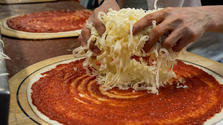 Person making pizza