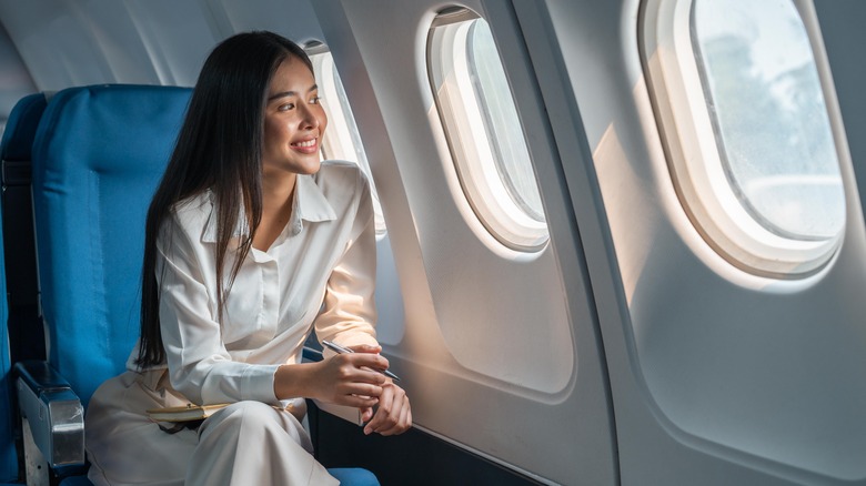 woman sitting by plane window