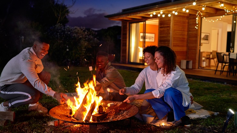 a group of people by a fire pit