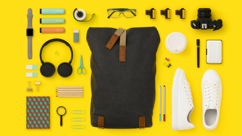 deconstructed travel backpack on yellow background