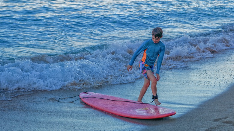 Boy surfing shore break Hawaii