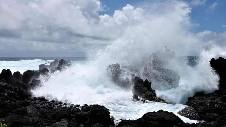 A massive wave crashes into the rocks in Hawaii