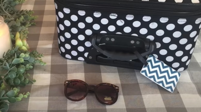 A suitcase with a chevron luggage tag