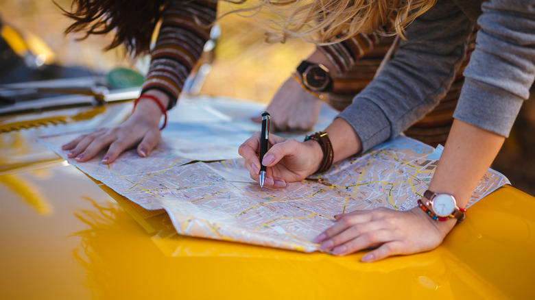 people planning map itinerary
