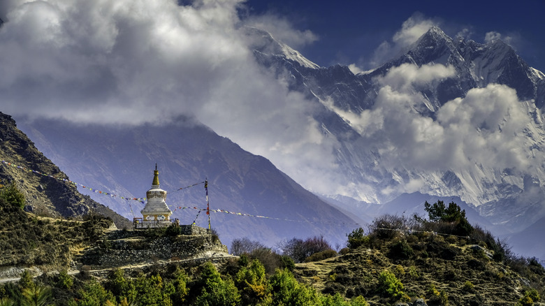 mountain monastery with prayer flags