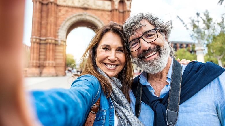 tourist couple taking selfie