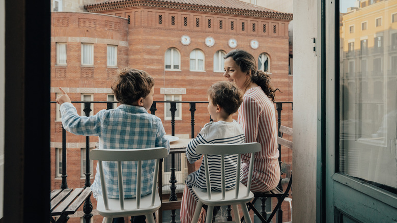 Mother children hotel balcony meal