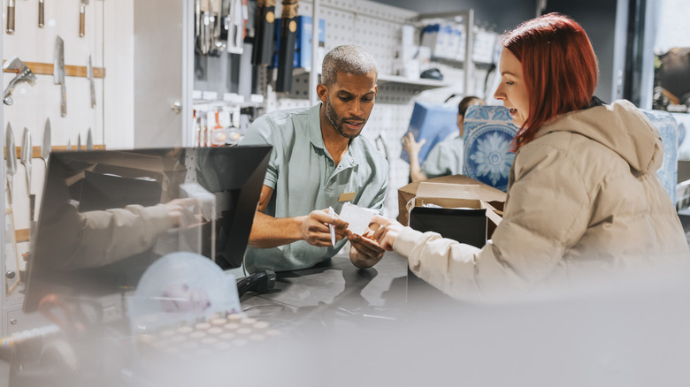 Salesperson checking shopper's receipt