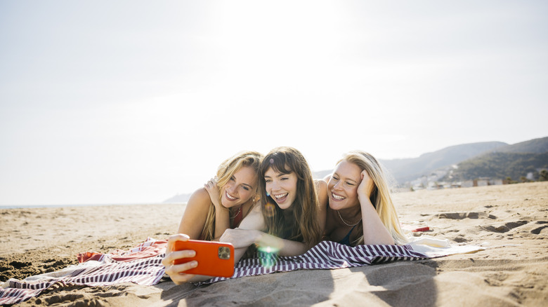 Travelers taking selfie at the beach