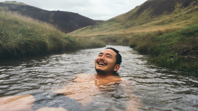 person in natural hot spring