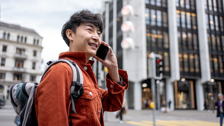 man on street using phone