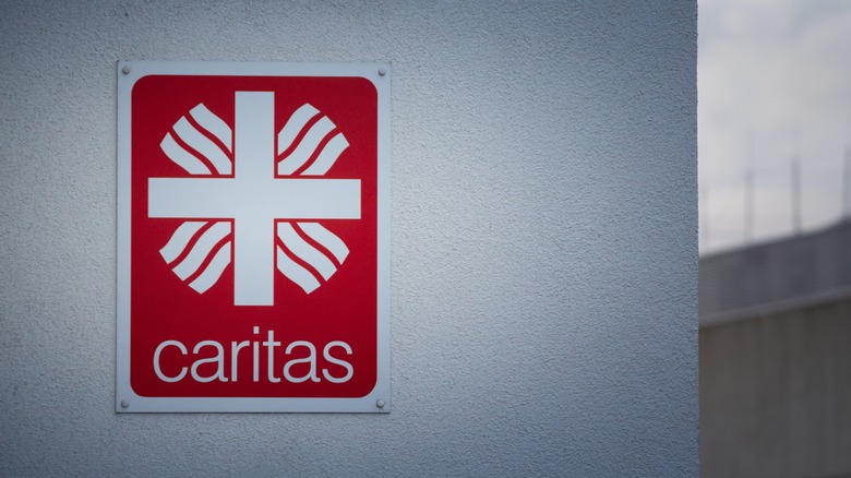 Caritas logo on a white wall