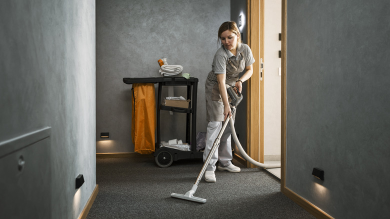 woman cleaning hotel hall