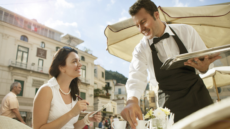 Customer and server at restaurant