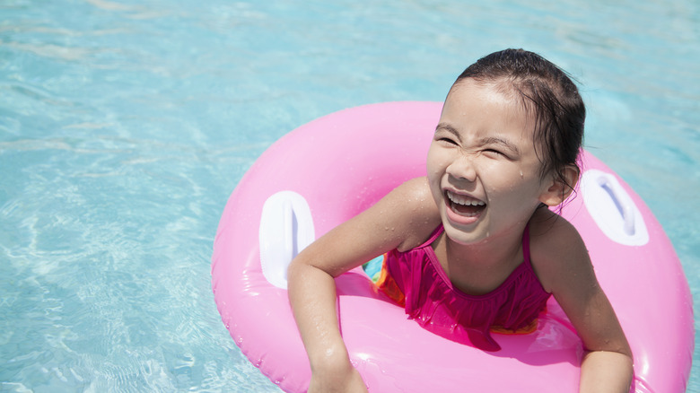 A little girl in pool floatie