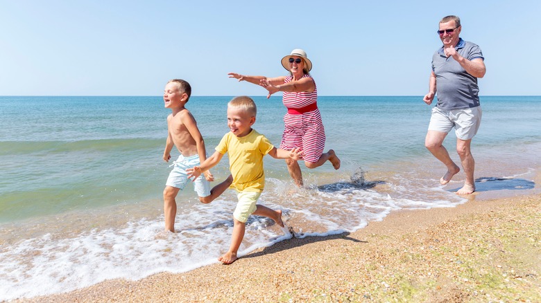 grandparents and grandchildren on the beach