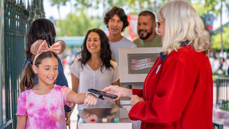 People using MagicBand+ at entrance