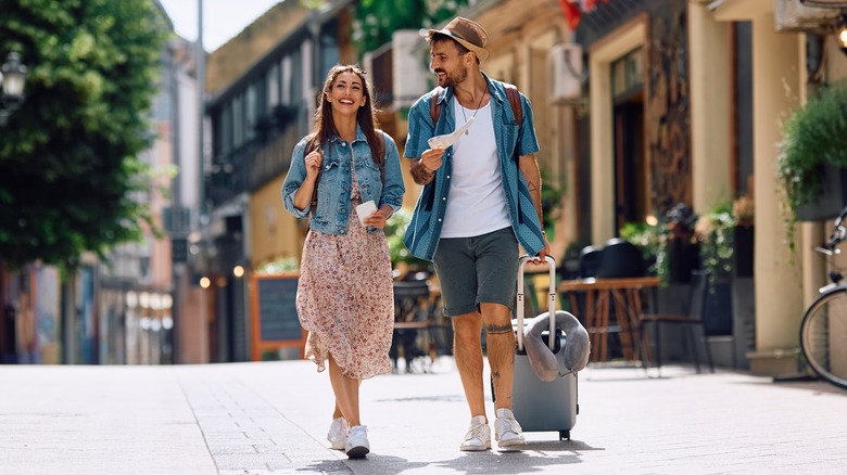 Traveling man and woman walking