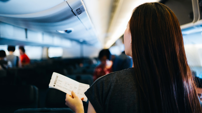 plane passenger holding boarding pass