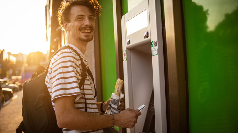 Traveler using an ATM
