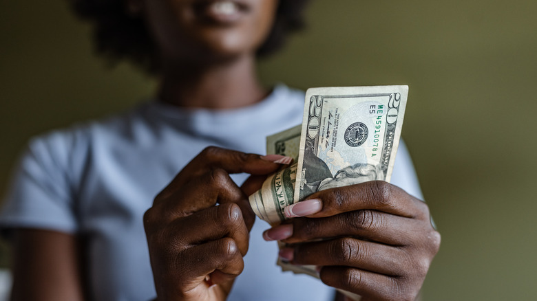 Woman holding US dollars