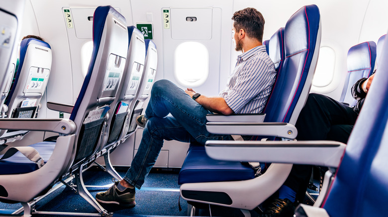 man in plane seat facing away