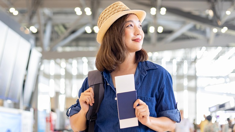 Traveler in airport holding passport