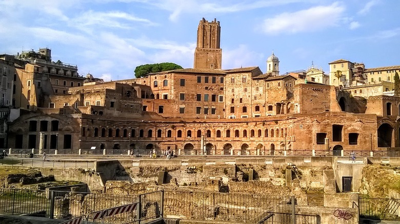 Stone ruins and beige buildings in Rome