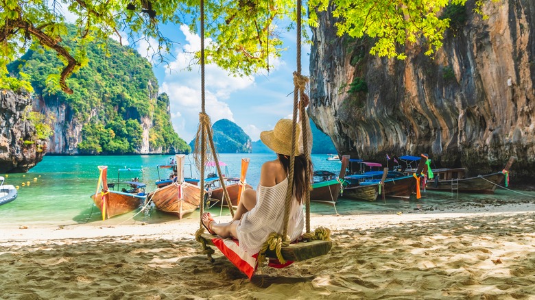 Woman swinging on Thailand beach