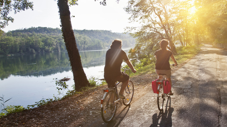 couple biking by the lake