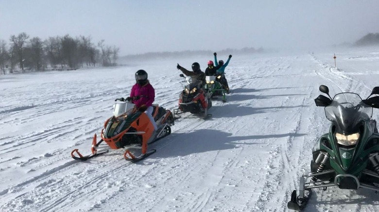 people on snowmobiles