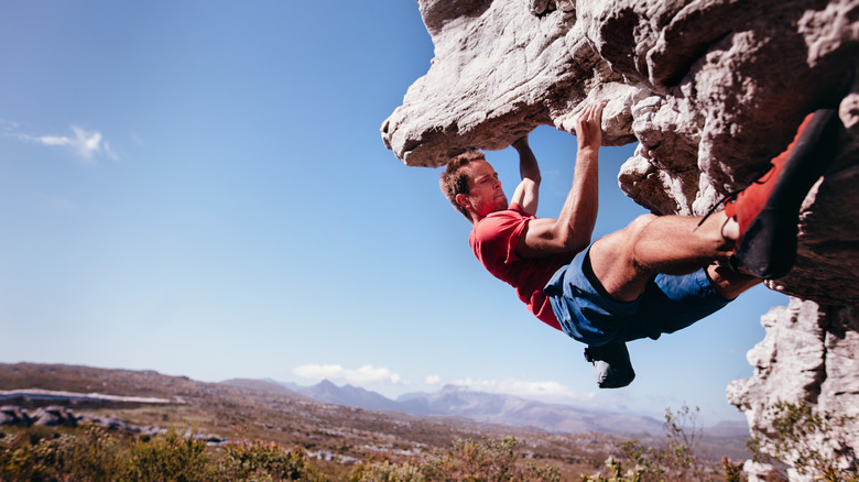 Man bouldering up a mountain