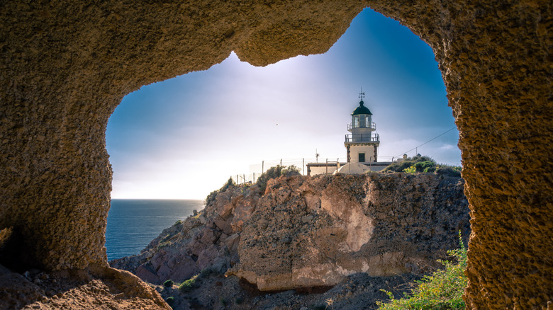 Lighthouse at Akrotiri framed by rock