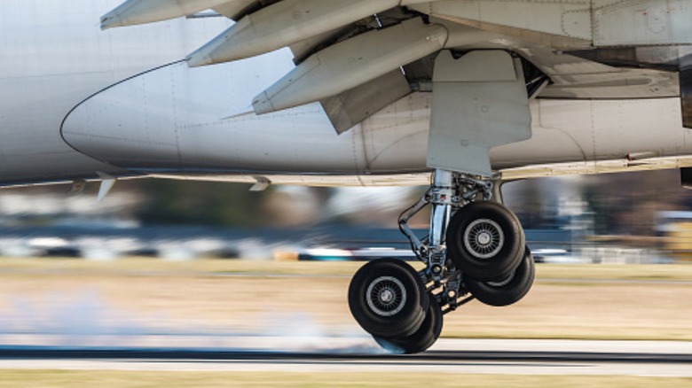 Plane tires about to land on runway