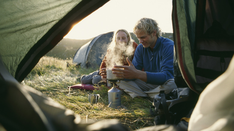 Campers cooking on portable stove