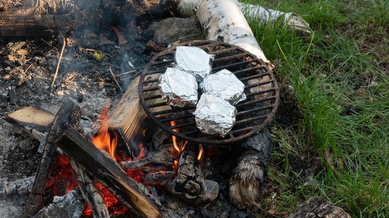 Foil-wrapped food on camping grill