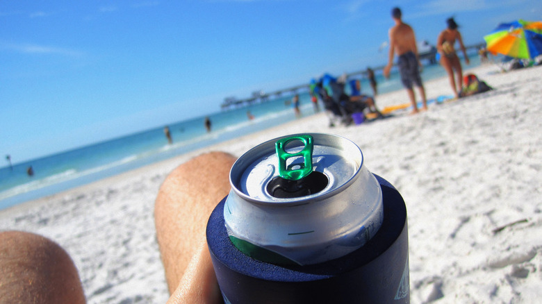 man holding beach beer 