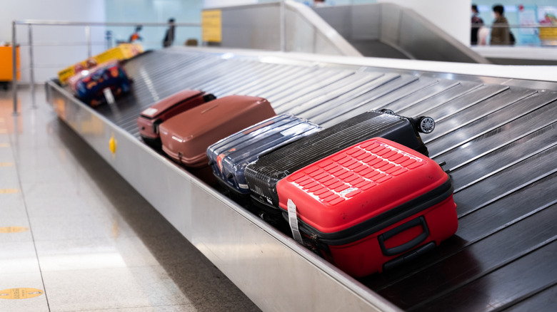 luggage on a carousel at the airport