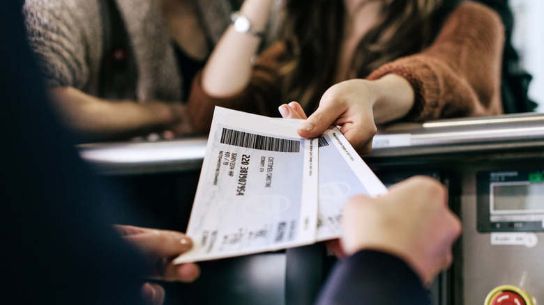 travelers getting their boarding passes at counter