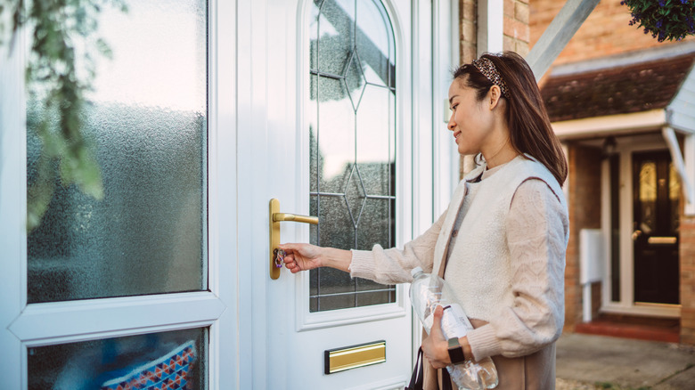 Young traveler unlocking door