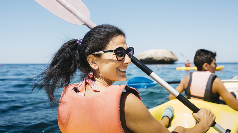 Travelers kayaking in the ocean