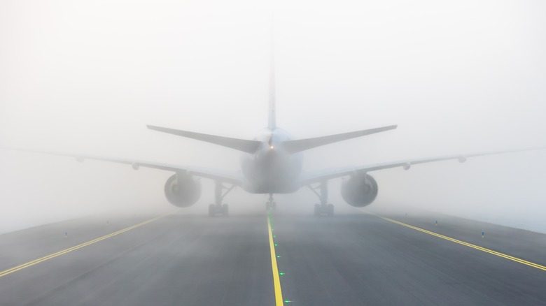 Plane landing in fog