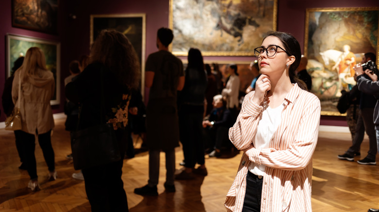 Woman looking at a painting in a museum