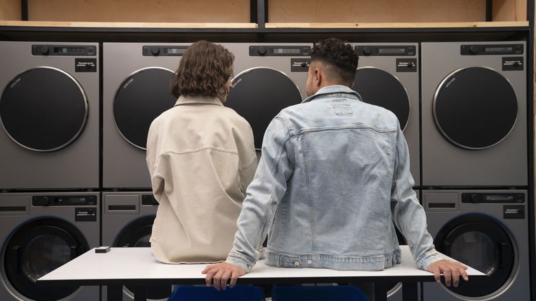 Couple sitting in a laundromat