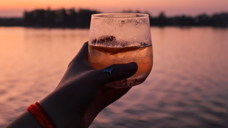 person holding drink on cruise ship