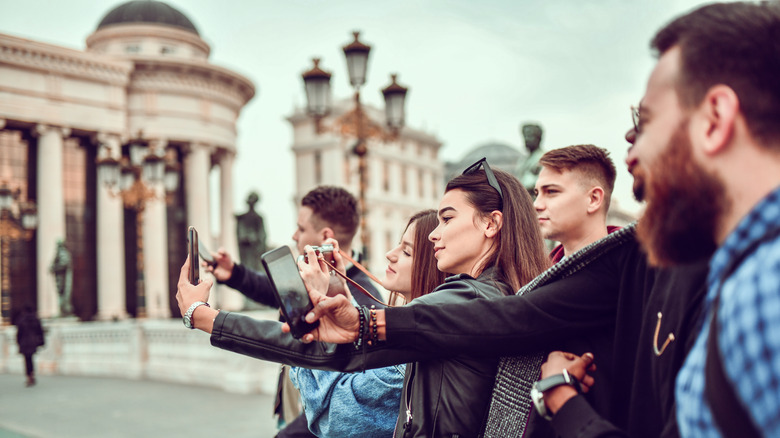 Tourists looking at their cell phones