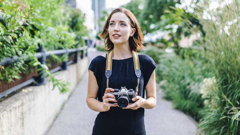 Traveler holding analog camera